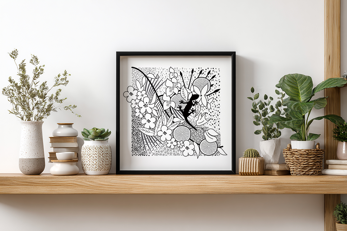 A black and white  tropical pattern.  The pattern consists of palm tree leaves, tropical flowers, circular grapefruits slices  with patterns created from parts of flowers in the background.  The central focal point is a gecko in solid black sat amongst the detail. This print is set in a black frame sat on a light wooden shelve with vases, ornaments and plants in plant pots on either side. 